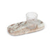 Oblong brown marble serving tray styled with a drinking glass