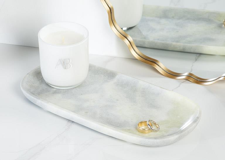 Green marble tray styled with a candle and decorative accessories