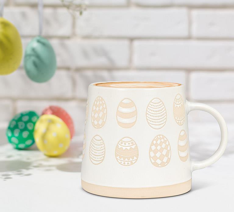 Ivory and sand patterned egg mug styled with colourful Easter eggs