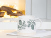 Pinecone stoneware mug styled with coffee in a bright modern kitchen