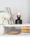 Small black lantern LED lamp displayed on a shelf with decorative home accents