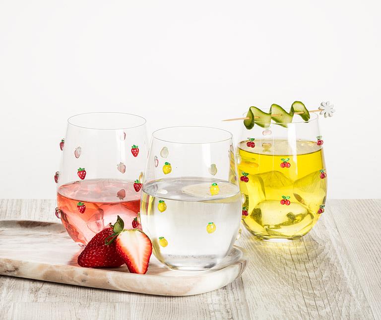 Abbott stemless wine glass with lemon design displayed with refreshments on a tabletop