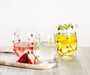 Abbott stemless wine glass with lemon design displayed with refreshments on a tabletop