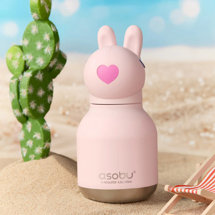 Asobu Mini Besties Bunny reusable insulated water bottle in an outdoor setting