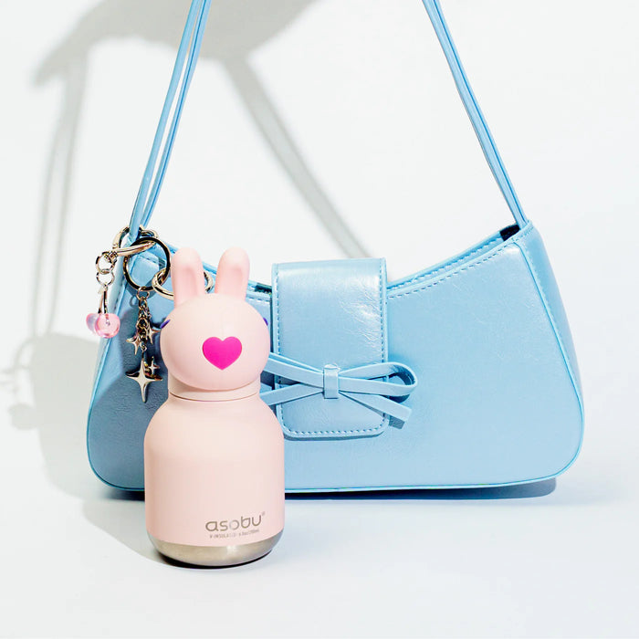 Asobu Mini Besties Bunny 6.7oz insulated stainless steel water bottle clipped to a blue handbag