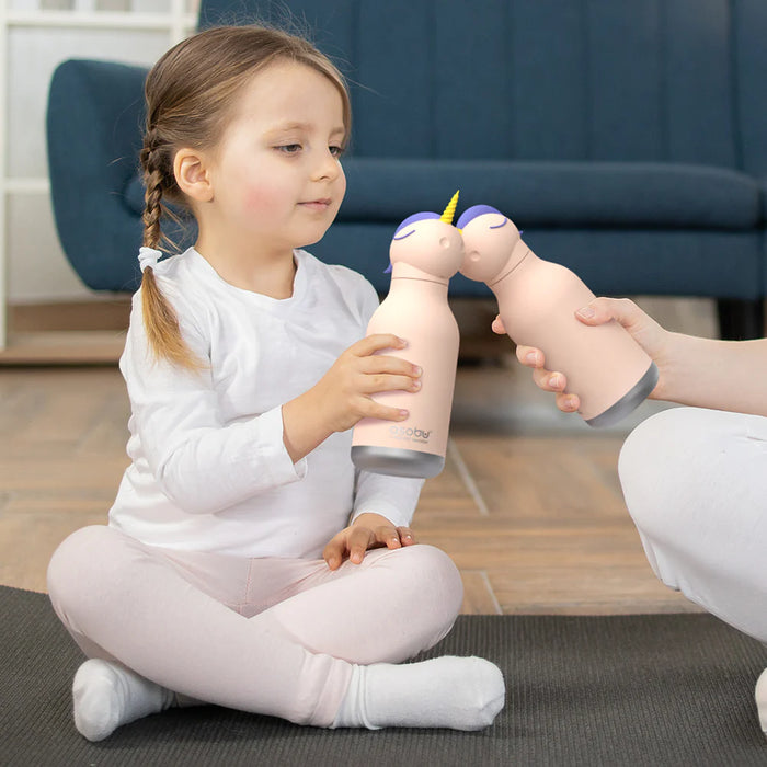 Child enjoying the Asobu Unicorn Bestie insulated water bottle with removable unicorn topper