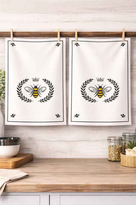 Set of 2 bee crest cotton kitchen towels hanging together in kitchen decor setting