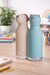 Pepper the Dog and Kiki the Cat Besties character bottles on desk lifestyle setup