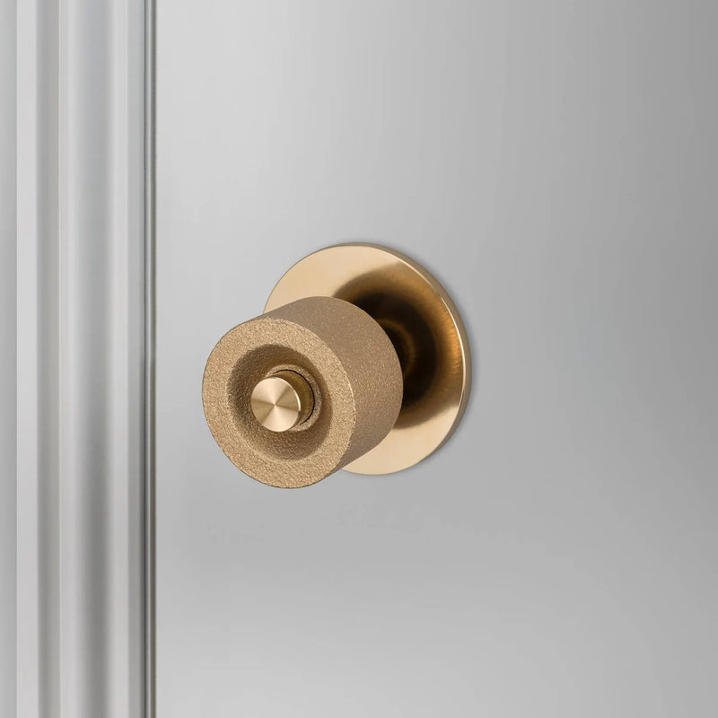 Buster + Punch Cast Door Knob Set in Brass finish mounted on interior door
