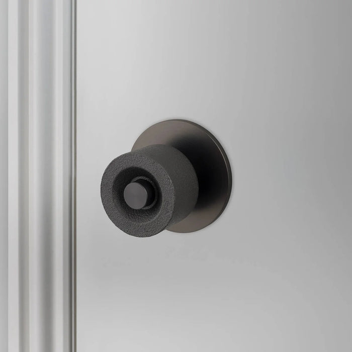 Angled view of Buster + Punch Cast Door Knob Set in Smoked Bronze finish