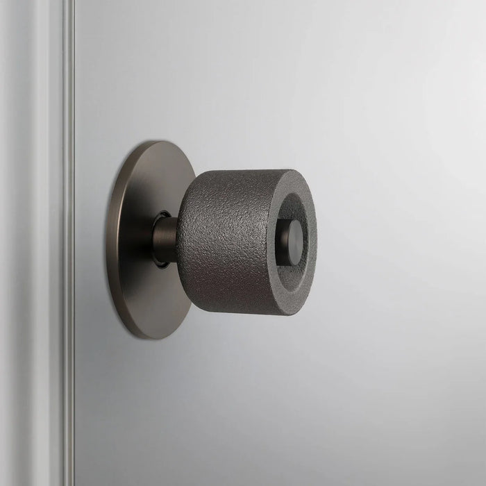 Side view of Buster + Punch Cast Door Knob Set in Smoked Bronze finish