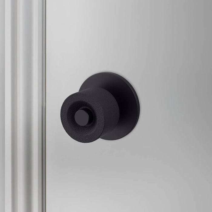 Front view of Buster + Punch Cast Door Knob Set in Welders Black finish