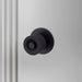 Front view of Buster + Punch Cast Door Knob Set in Welders Black finish
