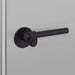 Angled close-up of Buster + Punch Cast Passage Door Handle Set in Smoked Bronze finish