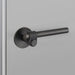 Angled view of Buster + Punch Cast Passage Door Handle Set in Welders Black finish