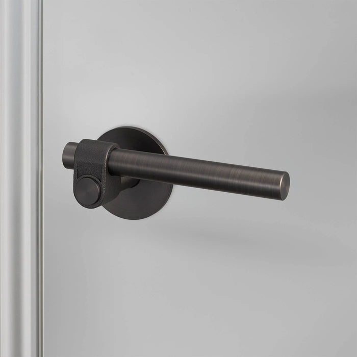 Angled view of Buster + Punch Cast Privacy Door Handle Set in Smoked Bronze finish
