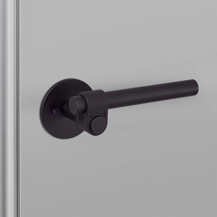 Angled close-up of Buster + Punch Cast Privacy Door Handle Set in Welders Black finish