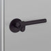 Angled close-up of Buster + Punch Cast Privacy Door Handle Set in Welders Black finish