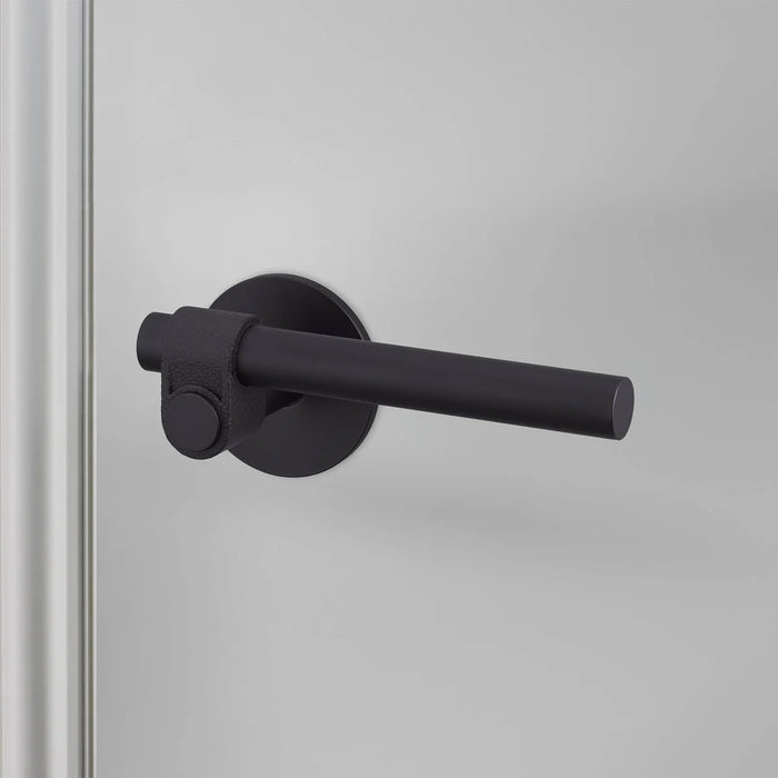 Close-up of Buster + Punch Cast Privacy Door Handle Set in Welders Black finish