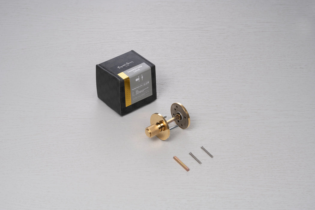 Buster + Punch Cast thumbturn lock in brass finish with packaging and installation hardware components