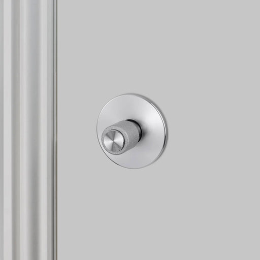 Side detail view of Buster + Punch Cast thumbturn lock in steel finish for bathroom privacy doors