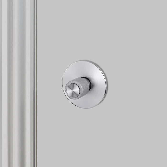 Side detail view of Buster + Punch Cast thumbturn lock in steel finish for bathroom privacy doors