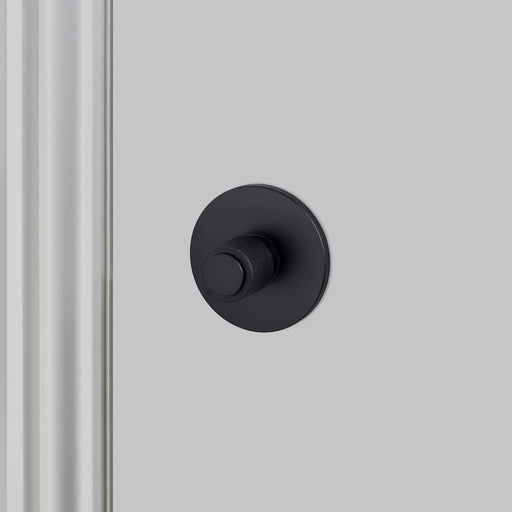 Buster + Punch Cast thumbturn lock in Welders Black finish installed on modern bathroom door
