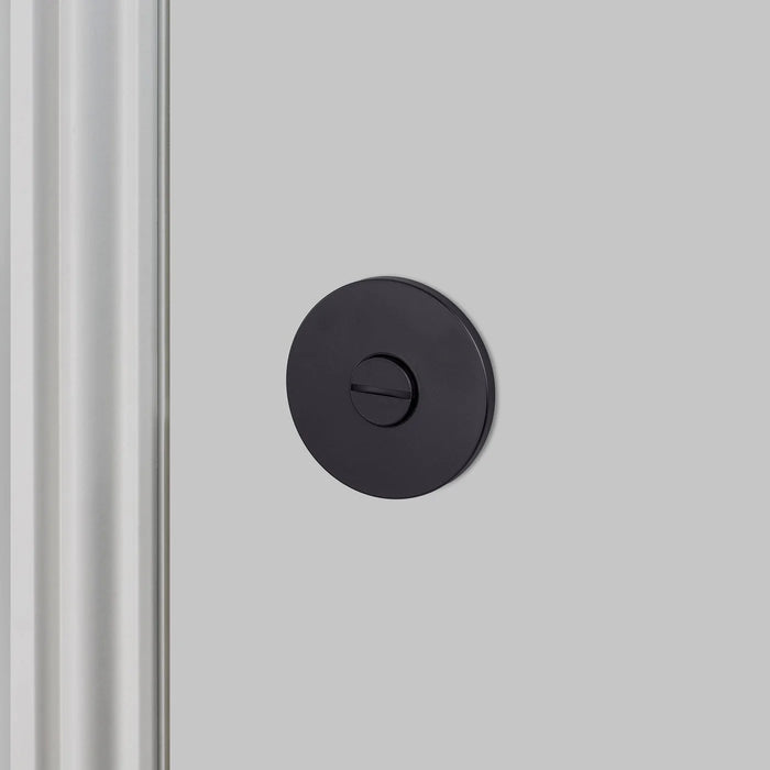 Front view of Buster + Punch Cast thumbturn lock in Welders Black finish for luxury bathroom hardware
