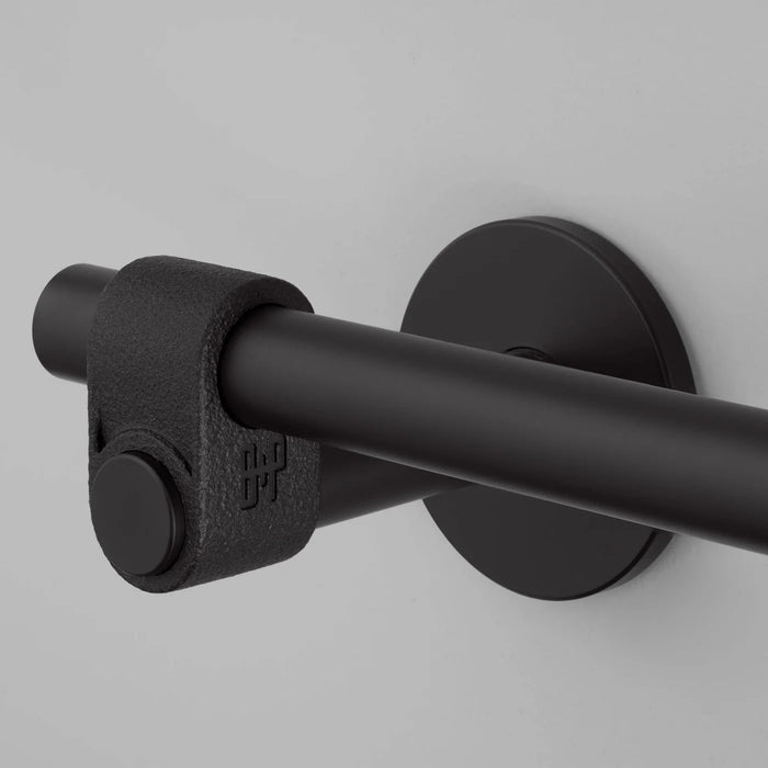 Close-up detail of Buster + Punch Cast toilet roll holder in welders black finish