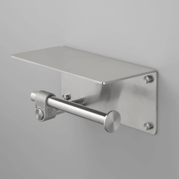 Angled view of Buster + Punch Cast toilet roll holder with shelf in steel finish