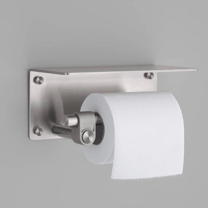 Buster + Punch Cast toilet roll holder with shelf in steel finish holding toilet paper roll