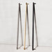 Buster + Punch Closet Bar Cross shown in brass, steel, and smoked bronze finishes
