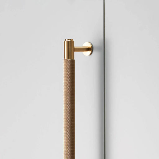 Close-up detail of Buster + Punch Closet Bar Cross in brass finish