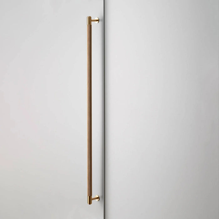 Buster + Punch Closet Bar Cross in brass finish mounted on wardrobe door