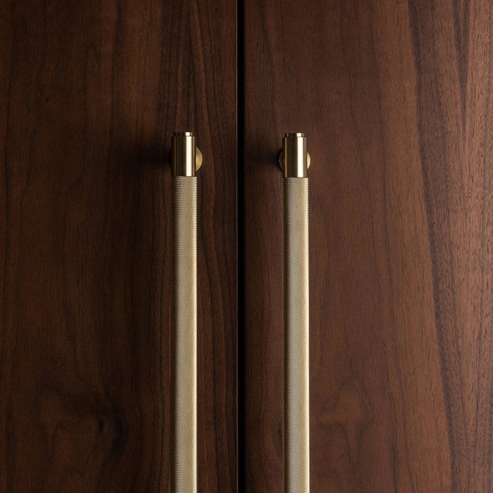 Buster + Punch brass closet bar installed on luxury wood wardrobe doors
