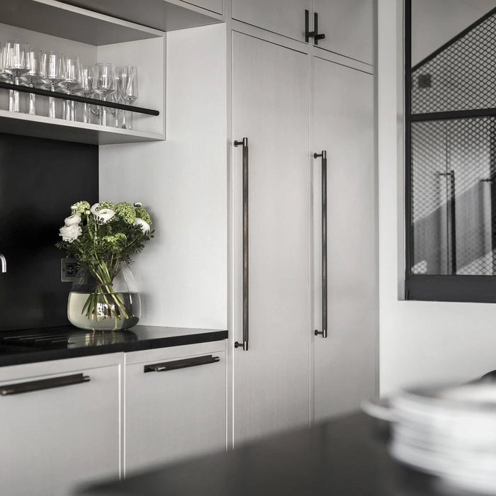 Smoked Bronze Buster + Punch Closet Bar Cross installed on contemporary kitchen cabinets