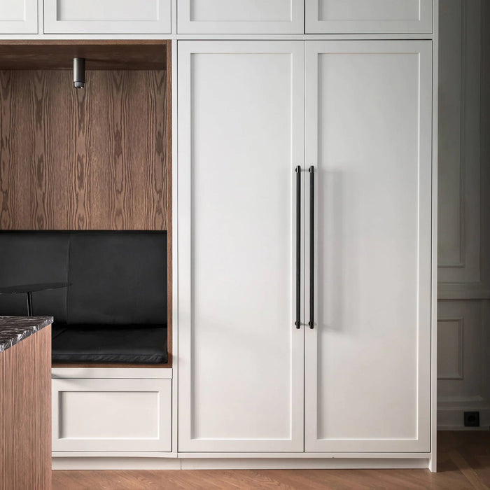Black finish Buster + Punch Closet Bar Cross installed on white closet cabinetry
