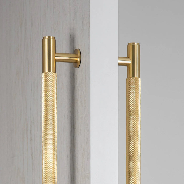 Close-up texture detail of Buster + Punch Closet Bar Double-Sided Cross in Brass finish