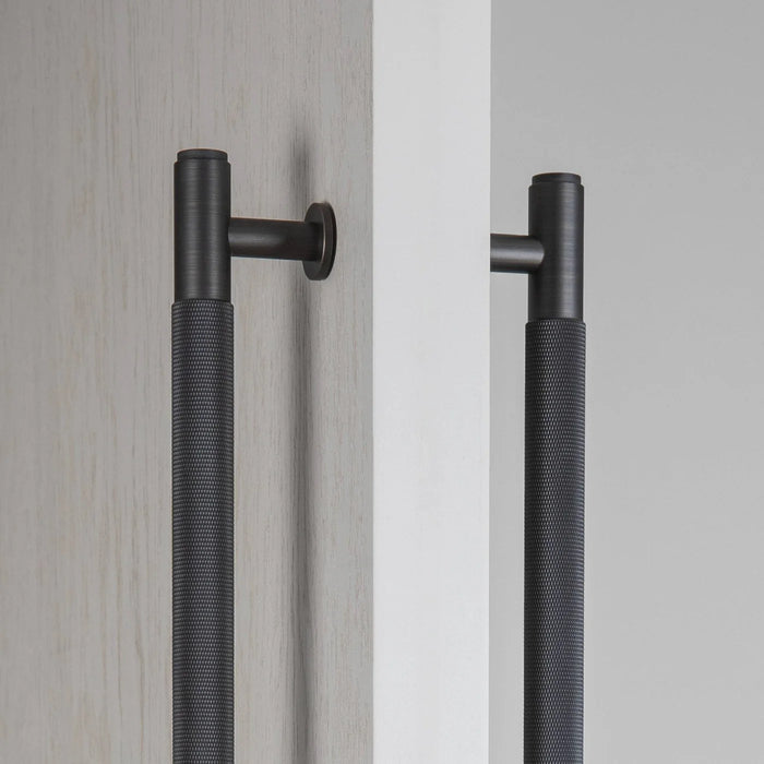 Detailed close-up of Buster + Punch Double-Sided Cross closet bar in Smoked Bronze finish