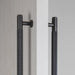 Detailed close-up of Buster + Punch Double-Sided Cross closet bar in Smoked Bronze finish