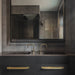 Buster + Punch Cross Pull Bar with Backplate in Brass finish in a modern dark bathroom vanity setting