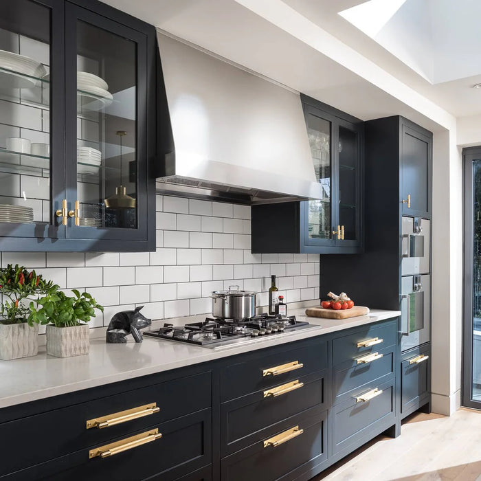 Buster + Punch Cross Pull Bar with Backplate in Brass finish installed on contemporary kitchen cabinets
