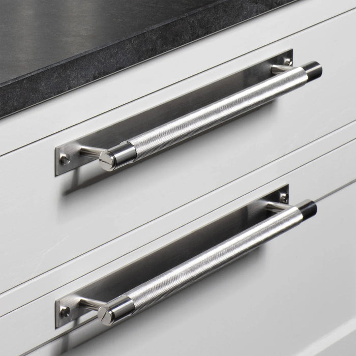 Steel Buster + Punch Cross Pull Bar with Backplate close up installed on white drawers