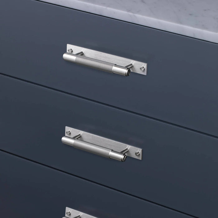 Steel Buster + Punch Cross Pull Bar with Backplate installed on modern cabinet drawers small size