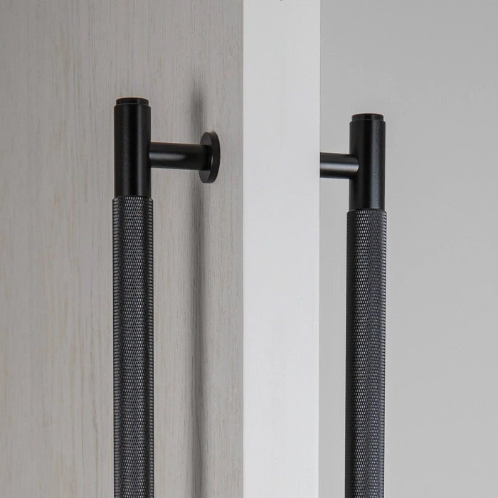 Close-up of black Buster + Punch Double-Sided Pull Bar Cross