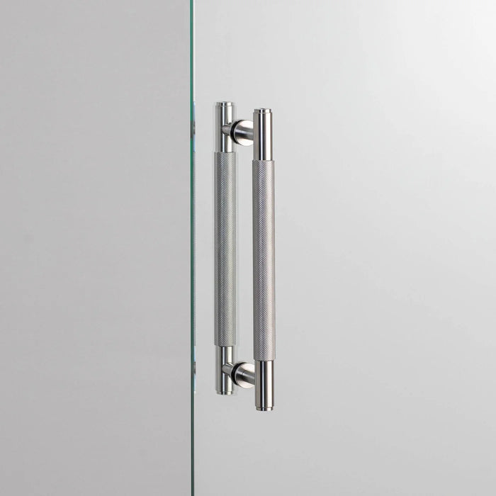 Buster + Punch Double-Sided Pull Bar Cross in steel finish front view on glass door