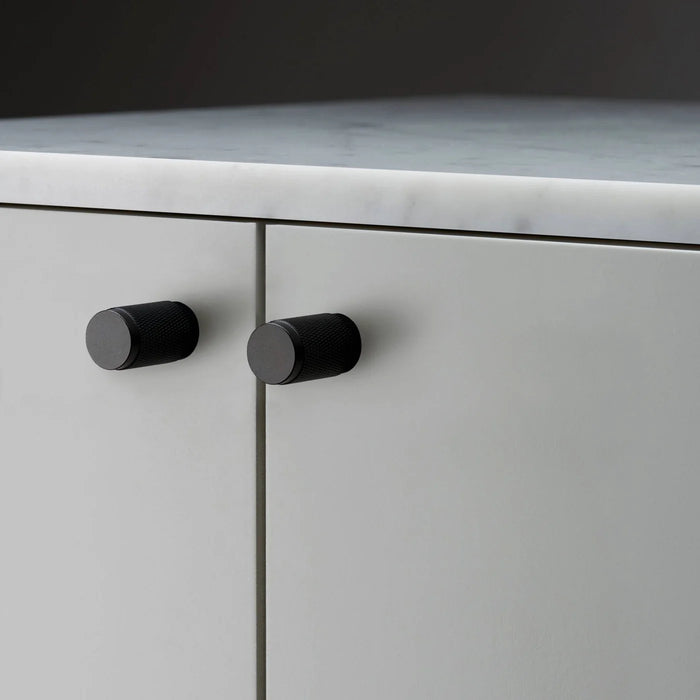 Buster + Punch Furniture Knob Cross in black finish installed on cabinet doors