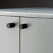Buster + Punch Furniture Knob Cross in black finish installed on cabinet doors