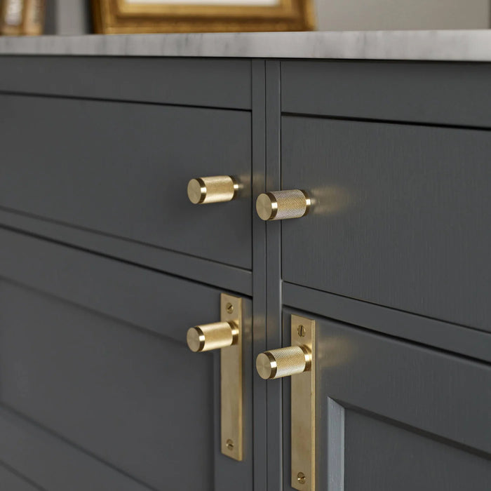 Buster + Punch brass cross furniture knobs featured in a luxury kitchen interior