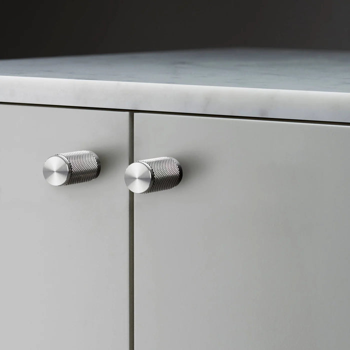 Buster + Punch Furniture Knob Cross in steel finish installed on cabinet doors